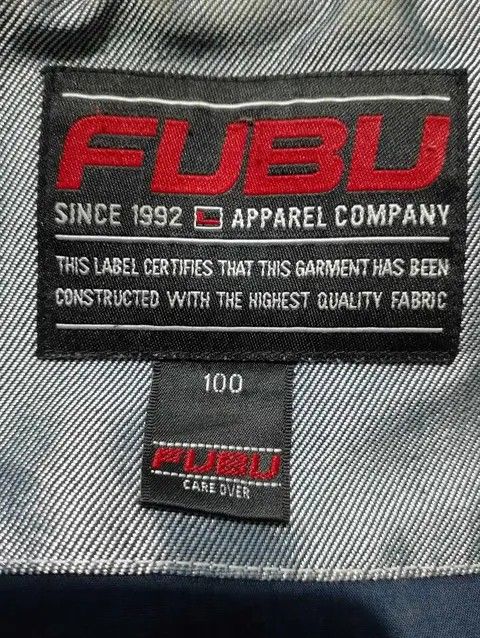 FUBU Jeans Company Hooded Jacket (Category: Coats, Jackets and Outerwear) located in Manila. Submitted by afreemf (Listing ID 1454670993, Image 3). Description: - Grey FUBU jacket with hood - FUBU Jeans Company branding on front and back - Shiny, slightly iridescent material - Darker panel details on sleeves - Ideal for casual wear - Please check photos for close-up details.