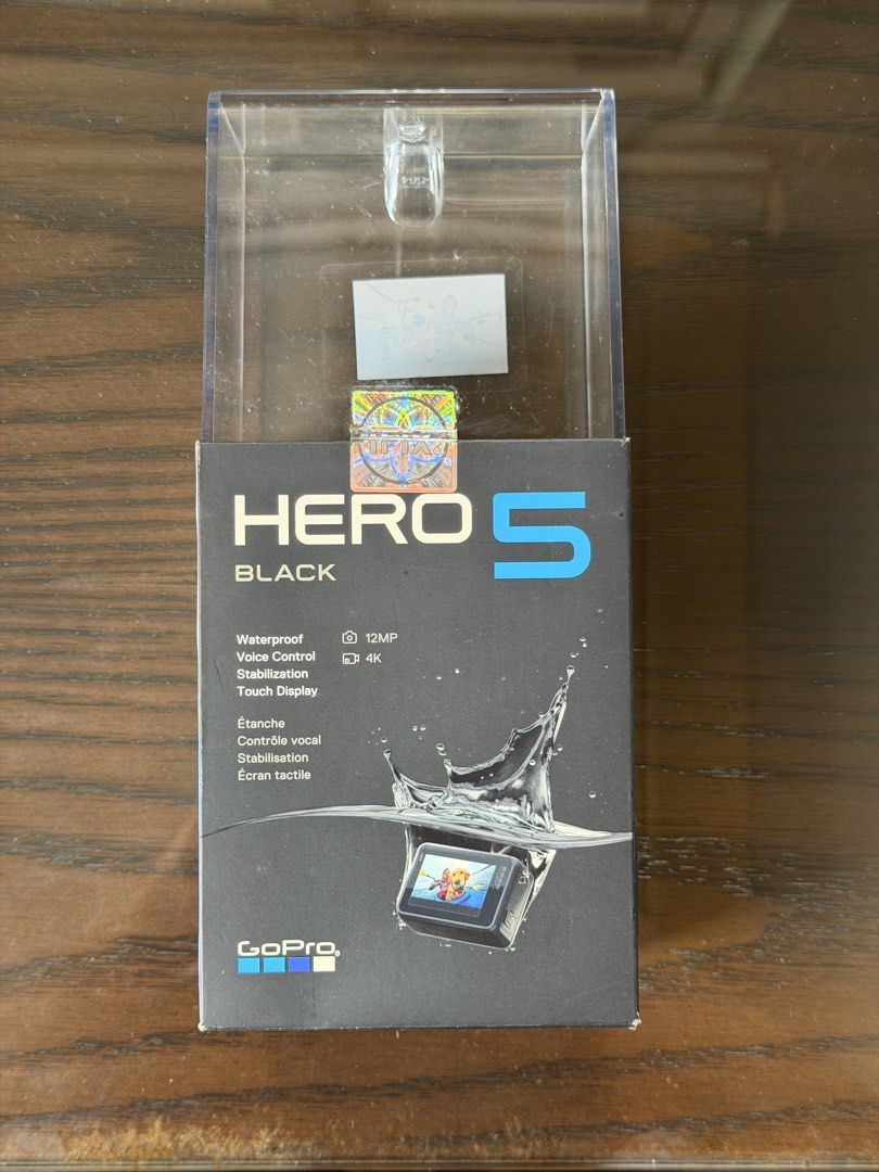 GoPro Hero 5 (Category: Cameras) located in Taguig. Submitted by dreamstudios (Listing ID 1412712988, Image 2). Description: - Black GoPro action camera - Features a lens and small screen - Includes the GoPro logo - Comes with a mounting bracket - Rubber coating slightly damaged.