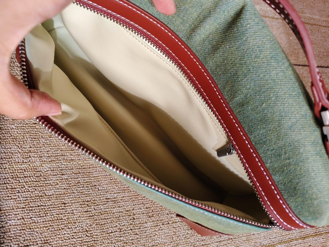 Green Canvas Unisex Sling Bag (Category: Luxury Bags & Wallets) located in Davao. Submitted by wangcollections (Listing ID 1454581815, Image 3). Description: - loro p. inspired bag - Stylish red leather trim and stitching - Secure zipper closure - Ideal for travel or everyday essentials - unisex -semi medium.