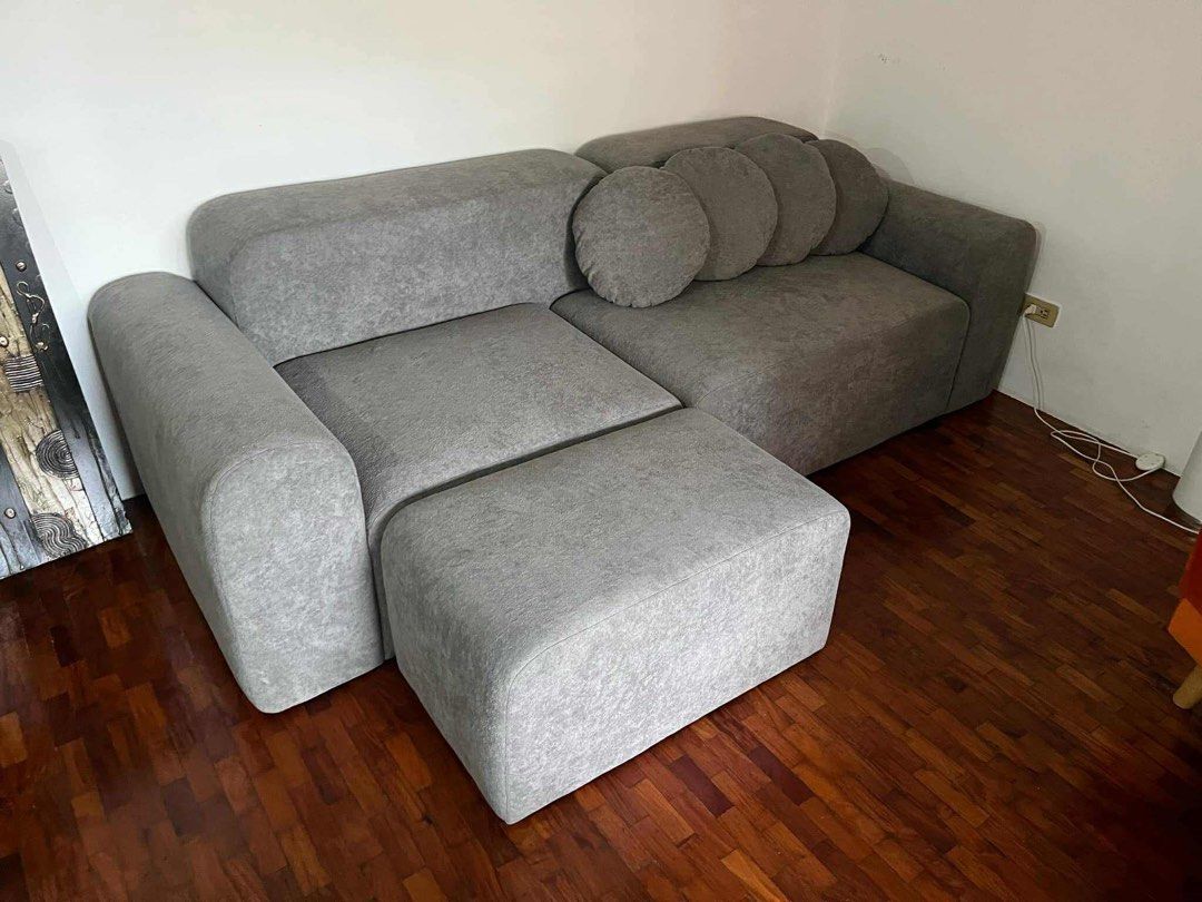 Grey Modular Sectional Sofa with Ottoman (Category: Sofas) located in Quezon City. Submitted by jennailao801 (Listing ID 1454639774, Image 2). Description: - Grey modular sectional sofa - Includes ottoman - Comes with round throw pillows - Upholstered in textured grey fabric - Versatile arrangement options - Ideal for living rooms or lounge areas - Ample seating space.