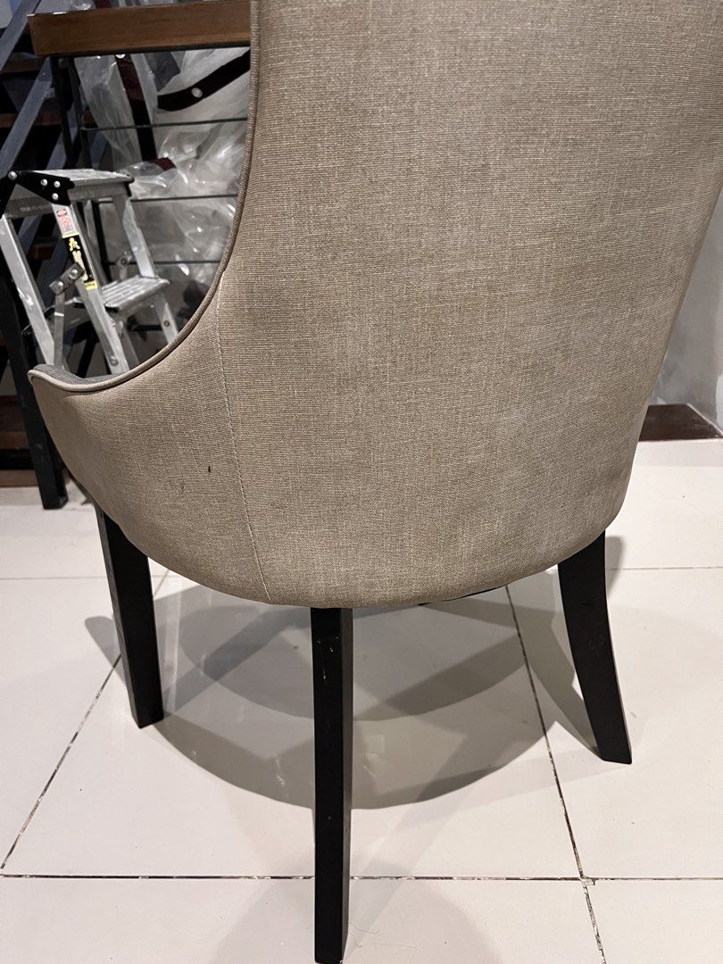 Grey Tufted Dining Chair with Silver Trim (Category: Chairs) located in Quezon City. Submitted by Jessesells (Listing ID 1454582712, Image 3). Description: - Elegant grey upholstered dining chair - Features a sophisticated diamond tufted backrest - Accented with chic silver piping along the edges - Sturdy dark wooden legs - Comfortable and stylish addition to any dining space - just needs cleanjng.