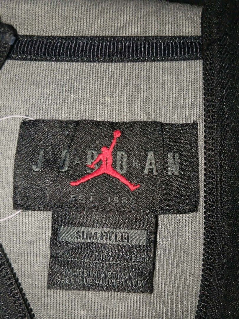 Jordan Grey Black Zip-Up Hoodie Jacket (Category: Coats, Jackets and Outerwear) located in Manila. Submitted by newbear.2b5a65 (Listing ID 1454720765, Image 3). Description: - Grey Jordan hoodie with black accents - Full zip closure - Iconic Jumpman logo on the chest - Made in Vietnam - Slim fit, size XXL - Ideal for casual wear or workouts.