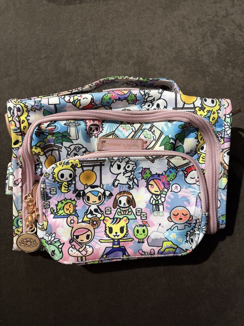 Jujube Toki Retreat bestie (Category: Purses & Pouches) located in Baguio. Submitted by nijnij15 (Listing ID 1454602824, Image 1). Description: - Super cute Jujube x Tokidoki cosmetic bag - Ideal for storing makeup or travel essentials - Includes a convenient top handle - Front zippered pocket for quick access - Stylish rose gold zipper pulls - Surprisingly spacious interior.