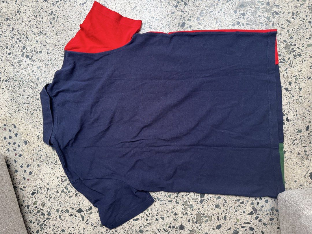 Lacoste Colourblock Polo Shirt (Category: Tshirts & Polo Shirts ) located in Manila. Submitted by rb.declutters (Listing ID 1454594530, Image 2). Description: - Classic size 4 Lacoste polo shirt - Bold navy, green, and red colorblock design - Embroidered Lacoste crocodile logo on chest - Button-up collar - Ideal for casual wear.