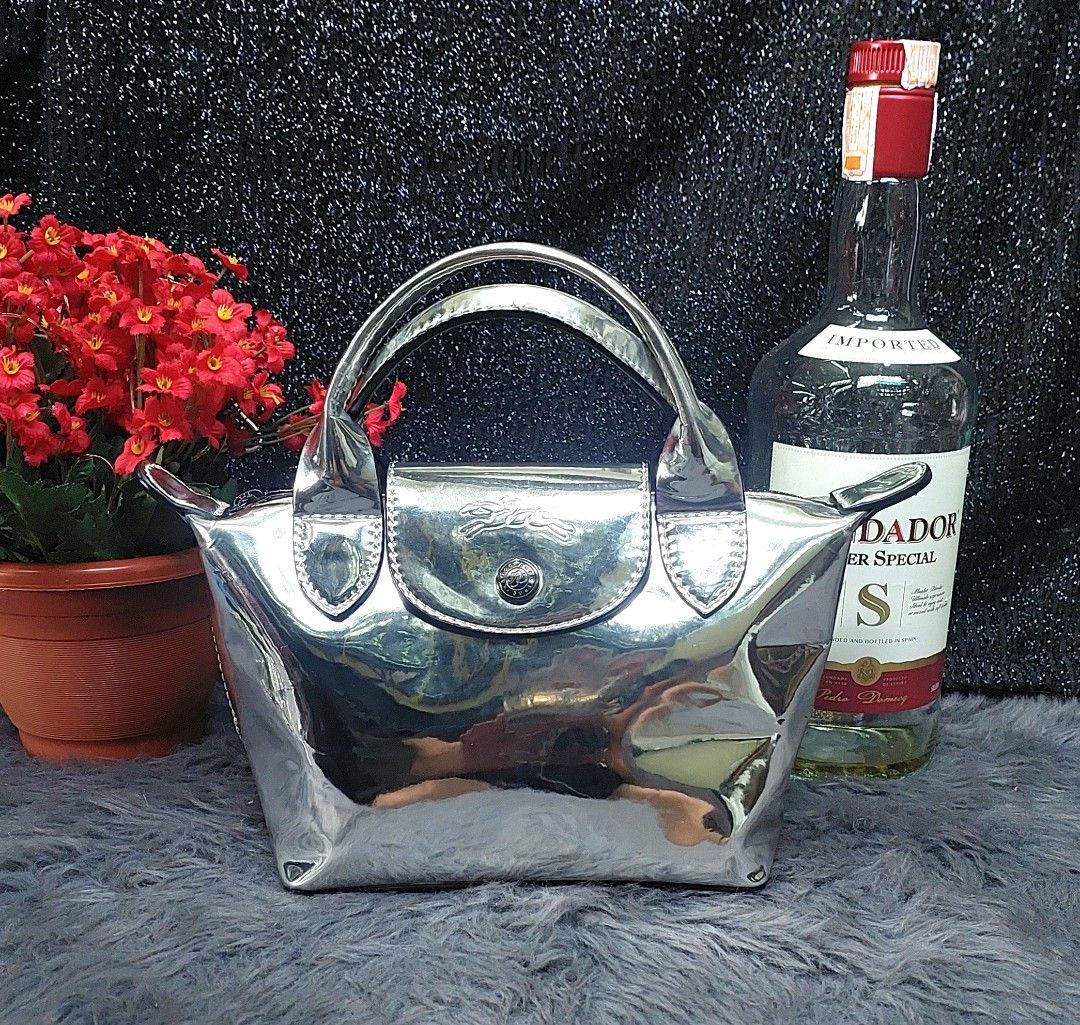 Longchamp Mini Metallic Patent Leather Handle Bag Silver (Category: Luxury Bags & Wallets) located in Quezon City. Submitted by ruthie3 (Listing ID 1454687997, Image 1). Description: issue: replacement chain sling - Cute mini Longchamp handle bag - Shiny silver metallic patent leather - Perfect size for essentials - Great for nights out or adding sparkle - Very eye-catching design.
