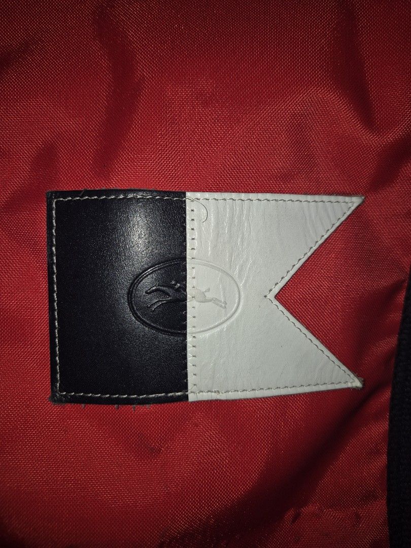 Longchamp Red Nylon Tote Bag (Category: Luxury Bags & Wallets) located in Manila. Submitted by rpaul88 (Listing ID 1454746955, Image 3). Description: - Brand: Longchamp - Material: Nylon - Color: Red - Origin: Made in France - Features: Black straps, black and white logo patch, zipper closure - Ideal for: Everyday use, travel - Interior: Spacious.