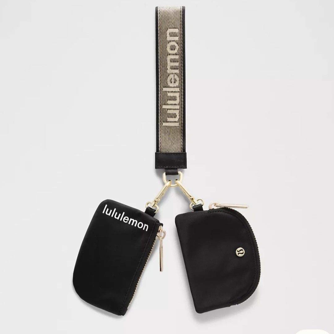 Lululemon Dual Pouch Wristlet Set Black/Gold (Category: Purses & Pouches) located in Bulacan. Submitted by bnbig (Listing ID 1454593519, Image 1). Description: - Lululemon Dual Pouch Wristlet Set - Includes two black zippered pouches - One pouch is semi-circular, the other is rectangular - Comes with a branded wrist strap featuring the Lululemon logo - Ideal for organizing small essentials.
