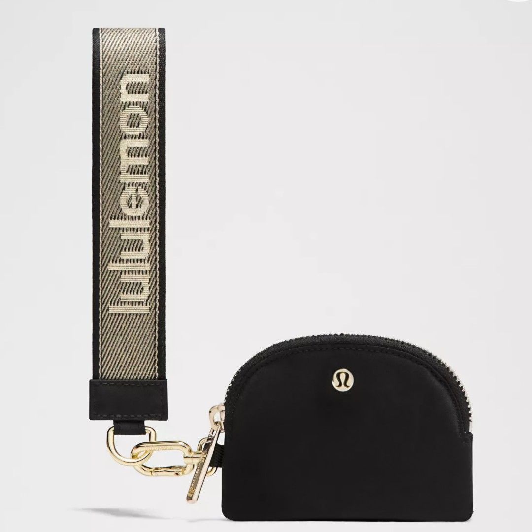 Lululemon Dual Pouch Wristlet Set Black/Gold (Category: Purses & Pouches) located in Bulacan. Submitted by bnbig (Listing ID 1454593519, Image 2). Description: - Lululemon Dual Pouch Wristlet Set - Includes two black zippered pouches - One pouch is semi-circular, the other is rectangular - Comes with a branded wrist strap featuring the Lululemon logo - Ideal for organizing small essentials.