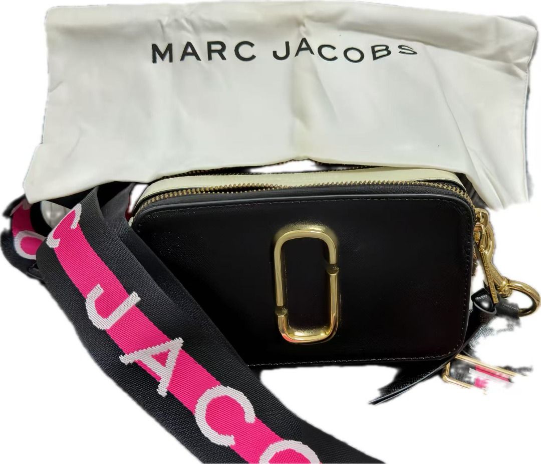 Marc Jacobs Snapshot Camera Bag with Dust Bag (Category: Luxury Bags & Wallets) located in Cavite. Submitted by simpletreasuresco. (Listing ID 1454590389, Image 2). Description: - Authentic Marc Jacobs Snapshot bag - Color: Black and Cream - Iconic double-J logo hardware - Bold strap with "MARC JACOBS" lettering (pink and white) - Includes original dust bag - Ideal for everyday use or travel.