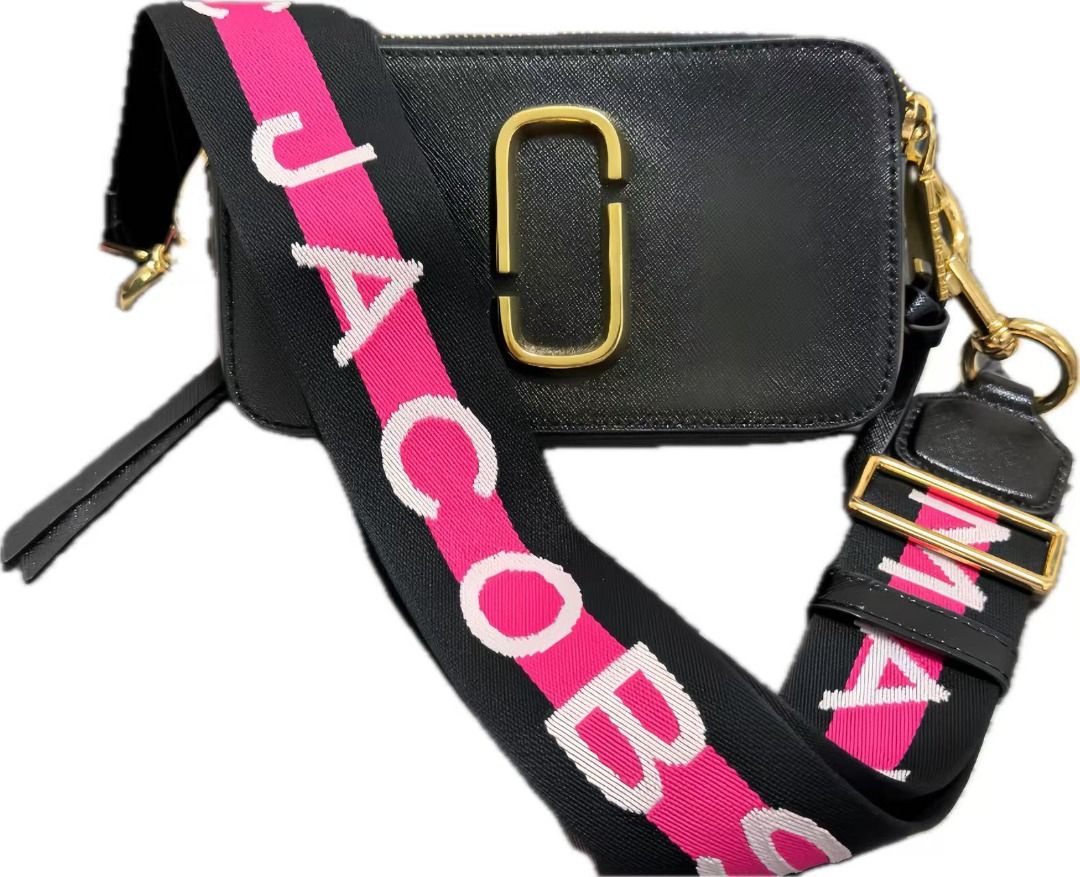 Marc Jacobs Snapshot Camera Bag with Dust Bag (Category: Luxury Bags & Wallets) located in Cavite. Submitted by simpletreasuresco. (Listing ID 1454590389, Image 1). Description: - Authentic Marc Jacobs Snapshot bag - Color: Black and Cream - Iconic double-J logo hardware - Bold strap with "MARC JACOBS" lettering (pink and white) - Includes original dust bag - Ideal for everyday use or travel.