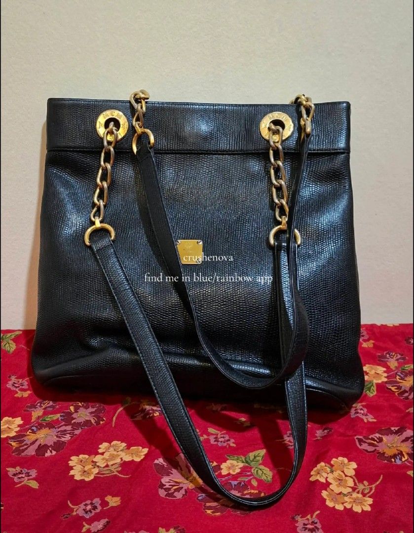 MCM Black Leather Chain Tote Bag (Category: Luxury Bags & Wallets) located in Caloocan City. Submitted by justthings.mnl (Listing ID 1454638802, Image 1). Description: - Genuine black leather MCM tote bag - Elegant gold chain detailing - Prominent MCM logo hardware on the front - Spacious interior to carry all your essentials - Comfortable shoulder straps for easy carrying - Versatile for everyday wear or a night out.