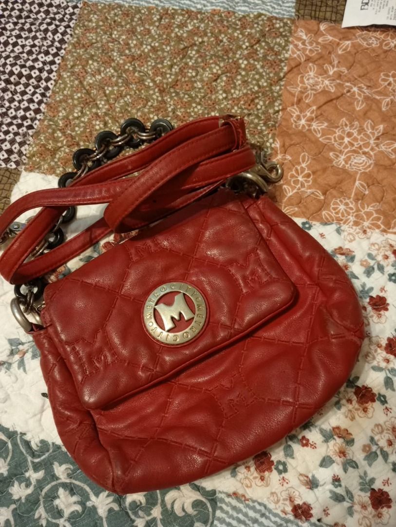 Metrocity Red Quilted Leather Shoulder Bag w/ Long Strap (Category: Luxury Bags & Wallets) located in Sagay. Submitted by seiriscollection (Listing ID 1454673975, Image 2). Description: Pre-owned Metrocity red leather handbag featuring an elegant quilted monogram design, signature Metrocity hardware, chain handle with black accents, long shoulder strap and secure zipper closure. Soft and supple leather with a clean interior and one small zippered