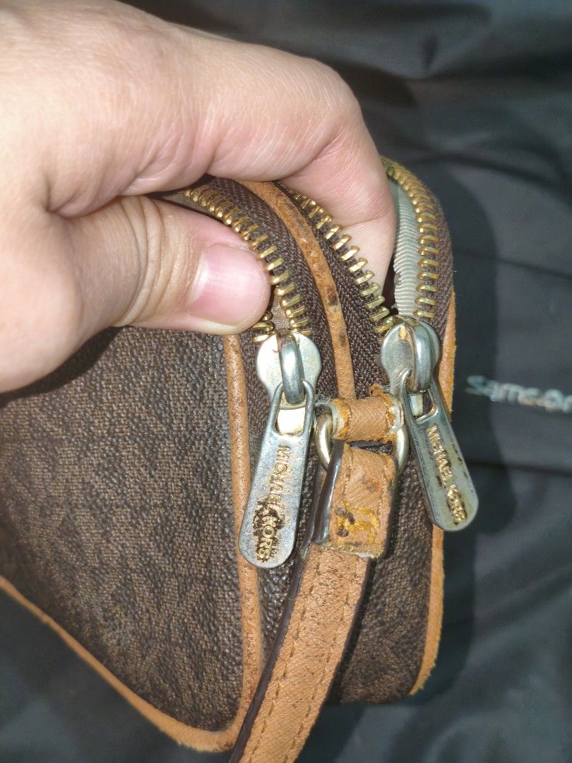 Michael Kors Monogram Crossbody Bag (Category: Luxury Bags & Wallets) located in Imus. Submitted by umusthave23 (Listing ID 1454726359, Image 3). Description: - Authentic Brown Michael Kors crossbody bag - Classic monogram print with tan leather trim - hardeare fading Dual zipper compartments for organization - Elegant gold-tone hardware - faded - Adjustable strap for comfortable wear - Ideal for everyday use, fits all your essentials.