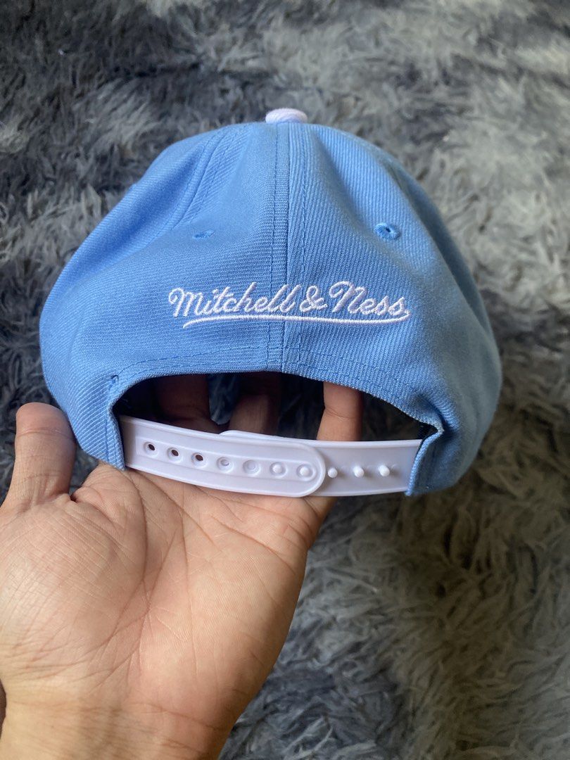 Mitchell & Ness LA Dodgers Snapback Cap (Category: Caps & Hats) located in Manila. Submitted by genesismak85421 (Listing ID 1454645314, Image 3). Description: - Light blue Mitchell & Ness snapback - Features iconic LA Dodgers logo on the front - 'Los Angeles' embroidered on the brim - Classic white snap closure at the back - Mitchell & Ness branding visible on the back and inside - Stylish green underbrim.