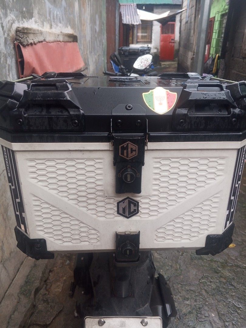 Motorcycle Top Box with Handle - Black and White (Category: Other Motorcycles Parts and Accessories) located in Manila. Submitted by zeus025 (Listing ID 1454651447, Image 1). Description: - White motorcycle top box with stylish black accents and graphic design. - Convenient top handle for easy portability. - Spacious interior for all your gear and essentials. - Securely attaches to the rear of your motorcycle..