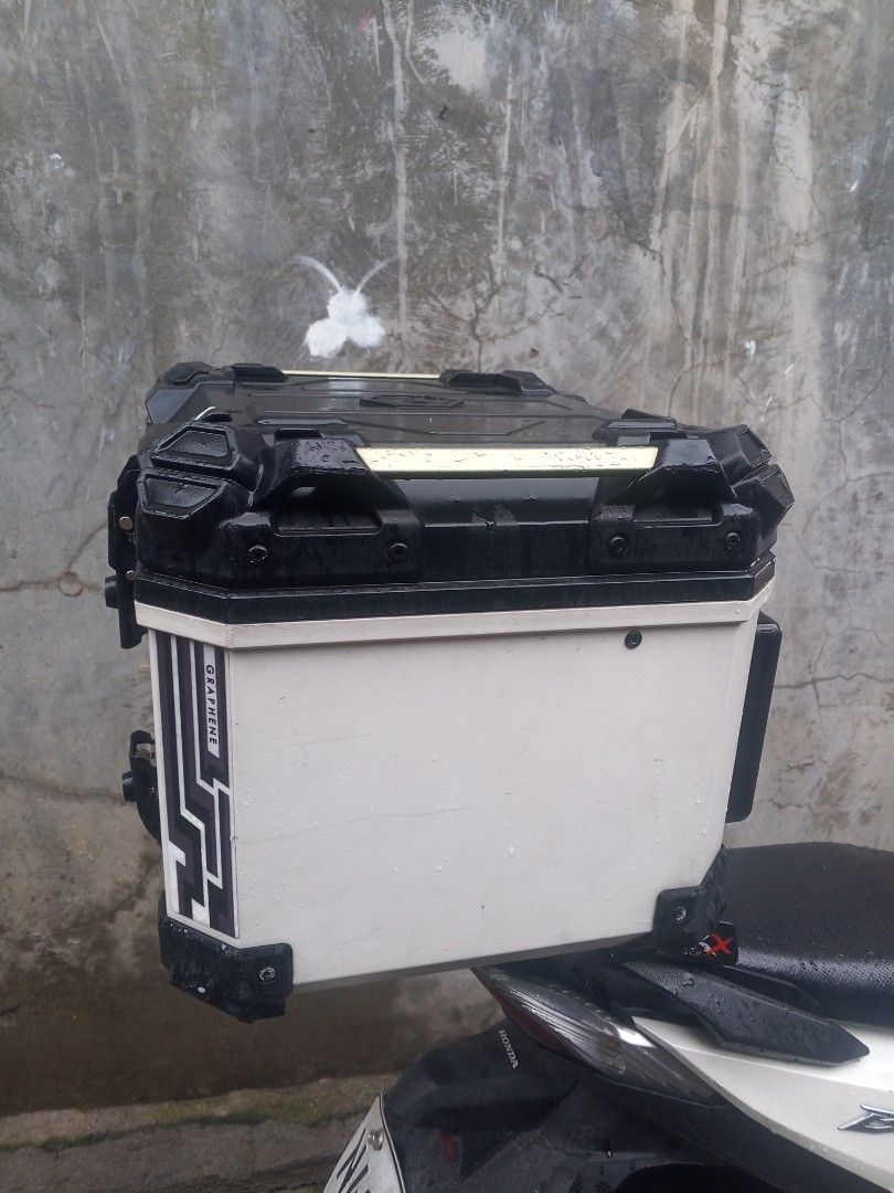 Motorcycle Top Box with Handle - Black and White (Category: Other Motorcycles Parts and Accessories) located in Manila. Submitted by zeus025 (Listing ID 1454651447, Image 3). Description: - White motorcycle top box with stylish black accents and graphic design. - Convenient top handle for easy portability. - Spacious interior for all your gear and essentials. - Securely attaches to the rear of your motorcycle..