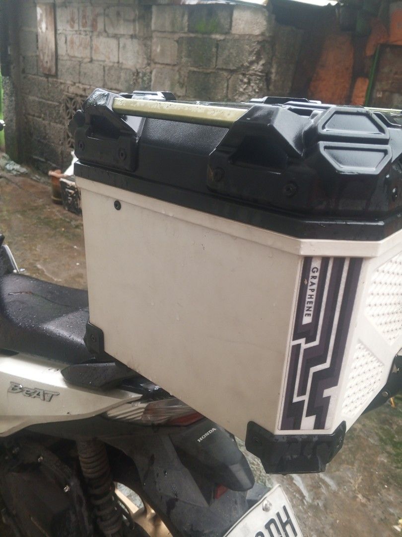 Motorcycle Top Box with Handle - Black and White (Category: Other Motorcycles Parts and Accessories) located in Manila. Submitted by zeus025 (Listing ID 1454651447, Image 2). Description: - White motorcycle top box with stylish black accents and graphic design. - Convenient top handle for easy portability. - Spacious interior for all your gear and essentials. - Securely attaches to the rear of your motorcycle..