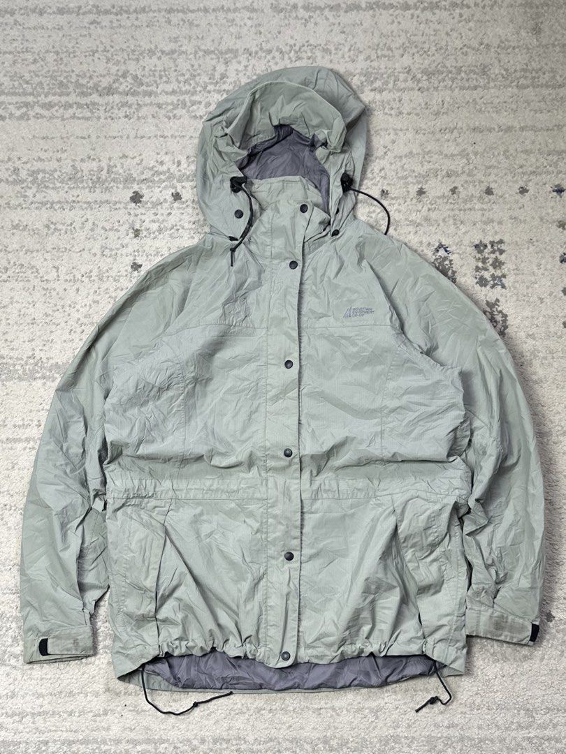 Mountain Equipment Co-op Rain Jacket (Category: Coats, Jackets and Outerwear) located in Daet. Submitted by thrifthings2018 (Listing ID 1454643025, Image 2). Description: - Lightweight rain jacket from Mountain Equipment Co-op (MEC) - Features a hood with adjustable drawstrings at the waist and hem - Button-up front closure - Versatile for outdoor adventures or everyday use - Measurements: 23 inches wide, 30 inches long.