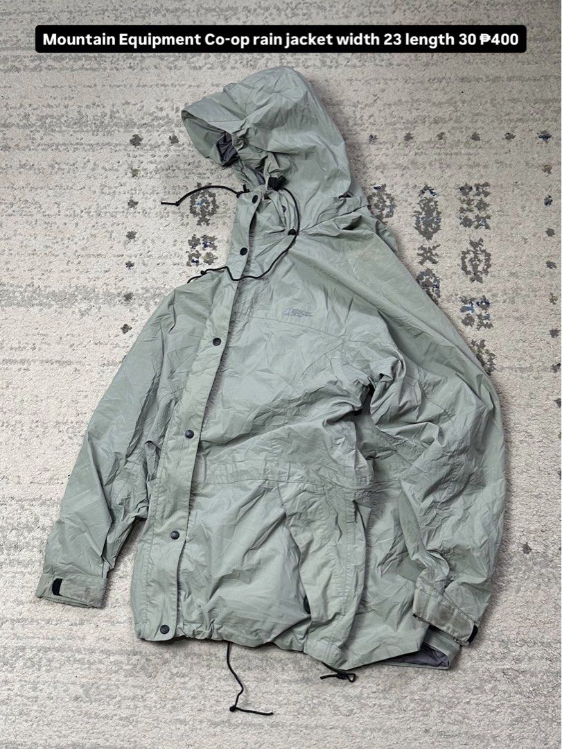 Mountain Equipment Co-op Rain Jacket (Category: Coats, Jackets and Outerwear) located in Daet. Submitted by thrifthings2018 (Listing ID 1454643025, Image 1). Description: - Lightweight rain jacket from Mountain Equipment Co-op (MEC) - Features a hood with adjustable drawstrings at the waist and hem - Button-up front closure - Versatile for outdoor adventures or everyday use - Measurements: 23 inches wide, 30 inches long.
