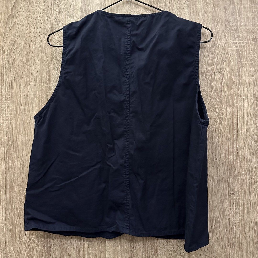 Navy Blue Button-Up Assymetrical Top (Category: Vests) located in Manila. Submitted by mjoycie (Listing ID 1454744905, Image 2). Description: - Navy blue vest - Button-up front - Two front pockets with red stitching detail - Round neckline - Ideal for layering - Versatile and easy to style.