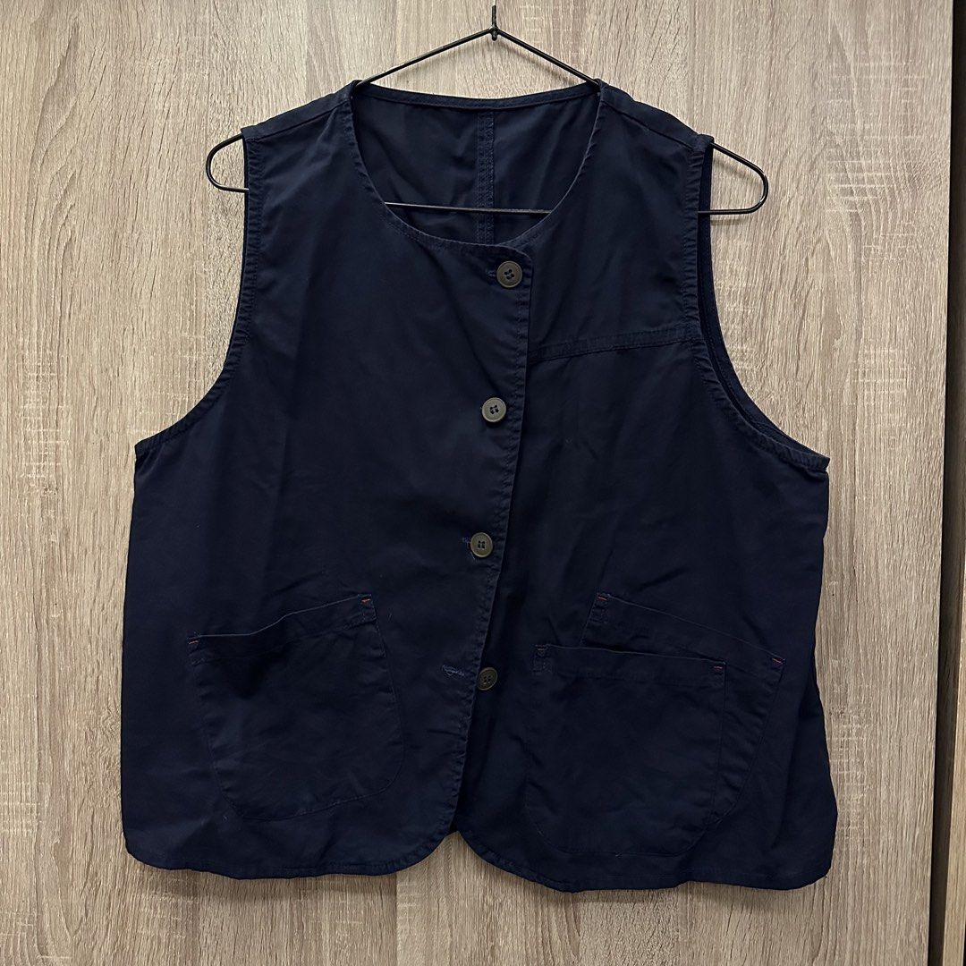 Navy Blue Button-Up Assymetrical Top (Category: Vests) located in Manila. Submitted by mjoycie (Listing ID 1454744905, Image 1). Description: - Navy blue vest - Button-up front - Two front pockets with red stitching detail - Round neckline - Ideal for layering - Versatile and easy to style.