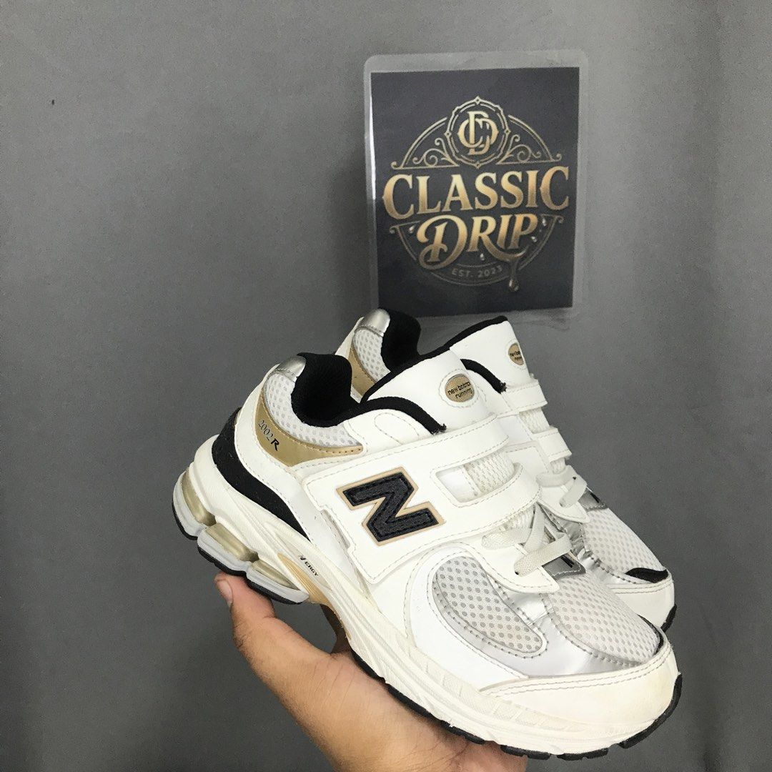 NEW BALANCE 2002R ( YOUTH ) (Category: Sneakers) located in Ozamiz City. Submitted by ClassicDrip (Listing ID 1454686146, Image 1). Description: New Balance 2002R Hook & Loop Little Kid Wide ‘White Black Gold’ PV2002PS -AUTHENTIC / LEGIT 💯 - 2 US / 33.5 EU / 20 CM -Like New Condition -Super nice and presentable in person -Guaranteed worth of money .