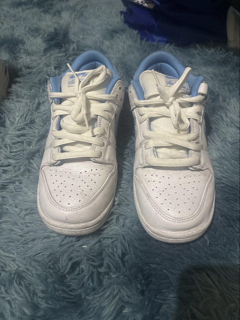 Nike SB Dunk Low "University Blue" White Light Blue (Category: Sneakers) located in Manila. Submitted by newshark_b237f7 (Listing ID 1454740370, Image 1). Description: - Nike SB Dunk Low in White and Light Blue - Classic silhouette, ideal for everyday wear and skating - Perforated toe box for breathability - "NIKE" branding prominently displayed on the heel complete box and extra laces - Crisp white laces - Unique graphic print on the inner sole.