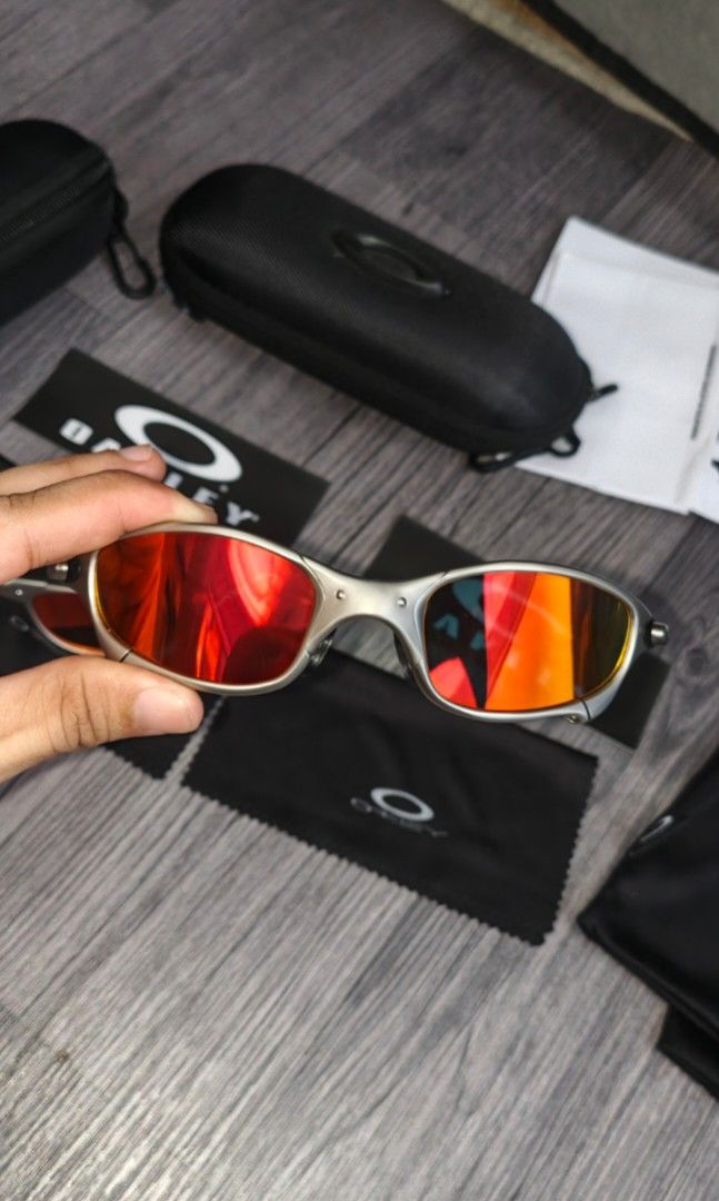 Oakley Juliet1 Sunglasses with complete inclusions (Category: Sunglasses & Eyewear) located in Manila. Submitted by ererane19 (Listing ID 1447497728, Image 1). Description: - 1 pair of iconic Oakley Juliet sunglasses - Includes original hard cases and soft pouches for both pairs - One pair features striking red lenses - The other pair comes with vibrant orange/yellow lenses - Perfect for Oakley collectors and enthusiasts - All accessories visible