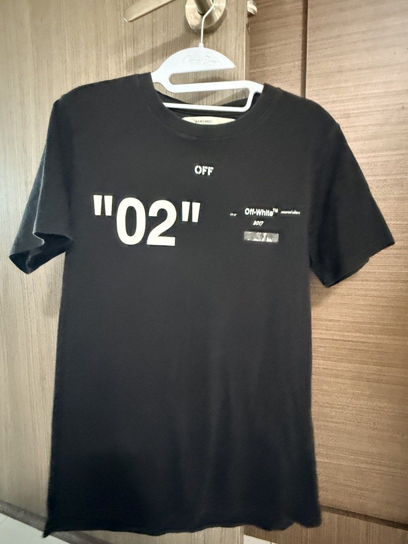 Off-White Tee (Category: Shirts) located in Singapore. Submitted by mrlabubu (Listing ID 1454631397, Image 1). Description: Original $200+ - Brand: Off-White Tee - Color: Black - Size: S (EU 48 / UK 38 / US 38) - Front Design: "02" graphic - Back Design: "Caravaggio" seasonal edition with text detail - Condition: Excellent - Features: Unique streetwear design, high-quality feel - Location: Bedok North (meetup available) - Delivery: Available.