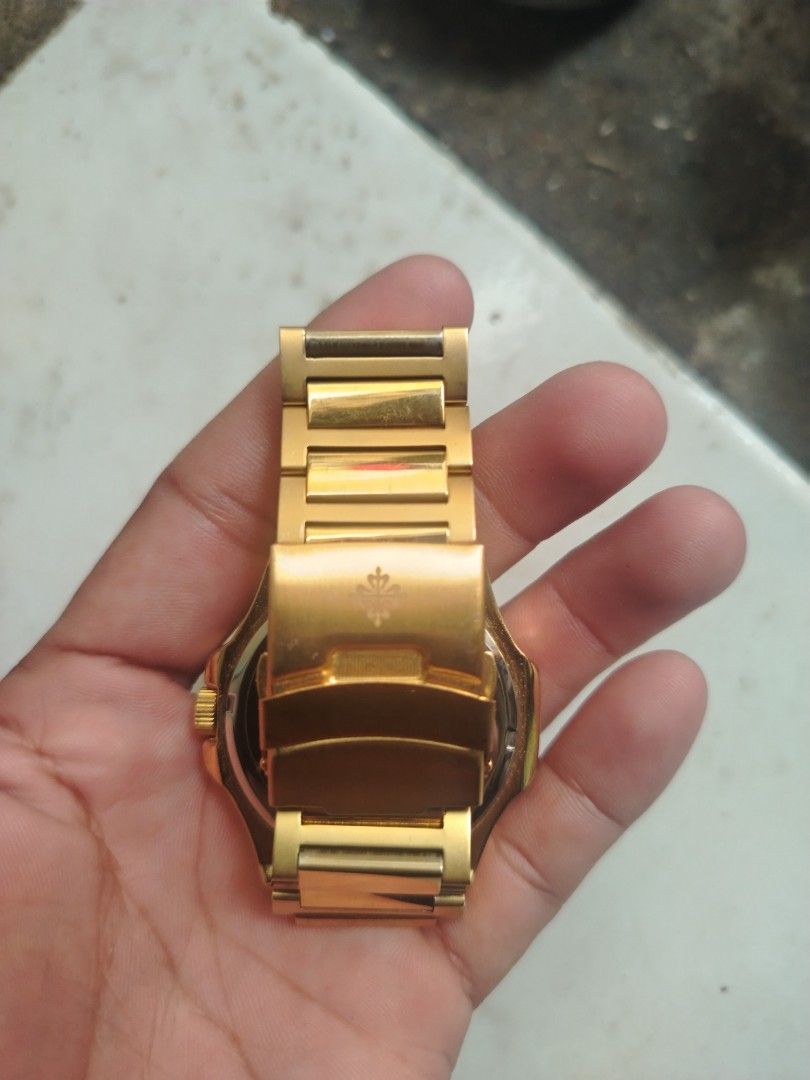 Patek Philippe Nautilus Gold Watch (Category: Luxury Watches) located in Quezon City. Submitted by secondlifestyleph (Listing ID 1454724263, Image 2). Description: Gold Patek Philippe Nautilus watch. Black dial with date window. Classic design. Bracelet is gold-toned. Clasp has the Patek Philippe emblem. Great for collectors or everyday wear. Message me for more details..