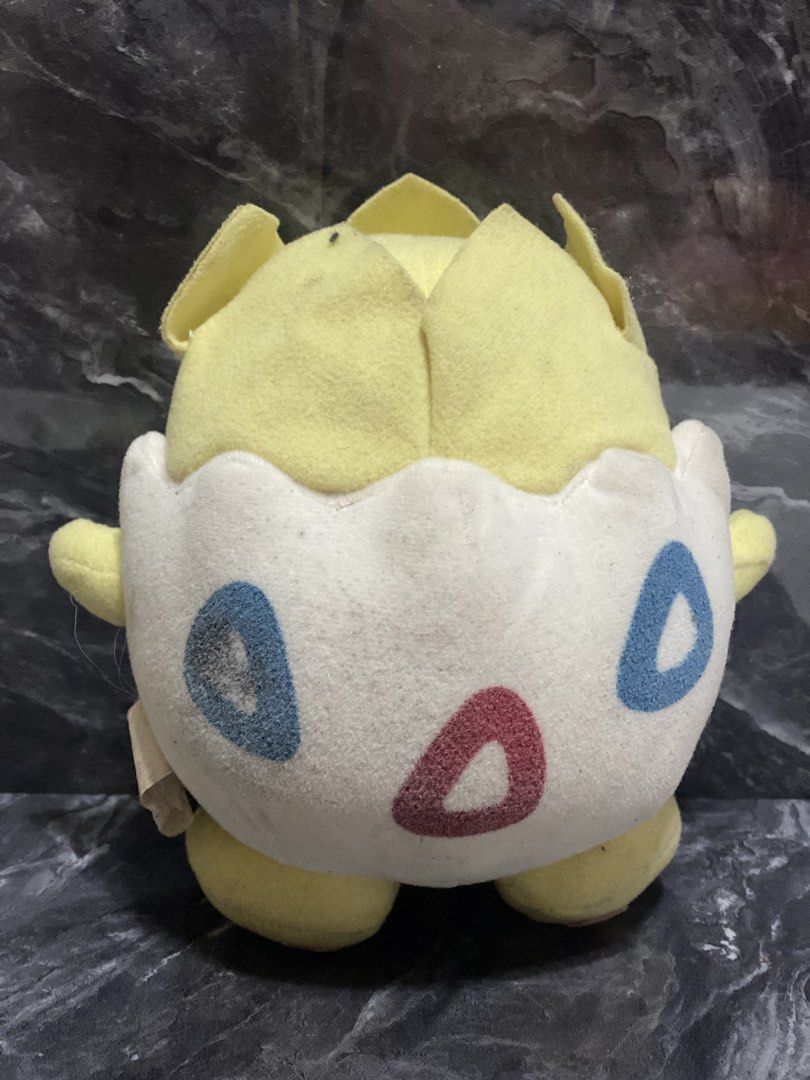 Pokemon Togepi Plush Toy (Category: Plushies & Soft Toys) located in Manila. Submitted by kuya_moto (Listing ID 1454610939, Image 2). Description: - Adorable Togepi plush toy - Classic yellow and white color scheme with red and blue markings - Super soft and cuddly material - Compact and portable size - Ideal gift for any Pokemon enthusiast - Ready to find its new trainer!.