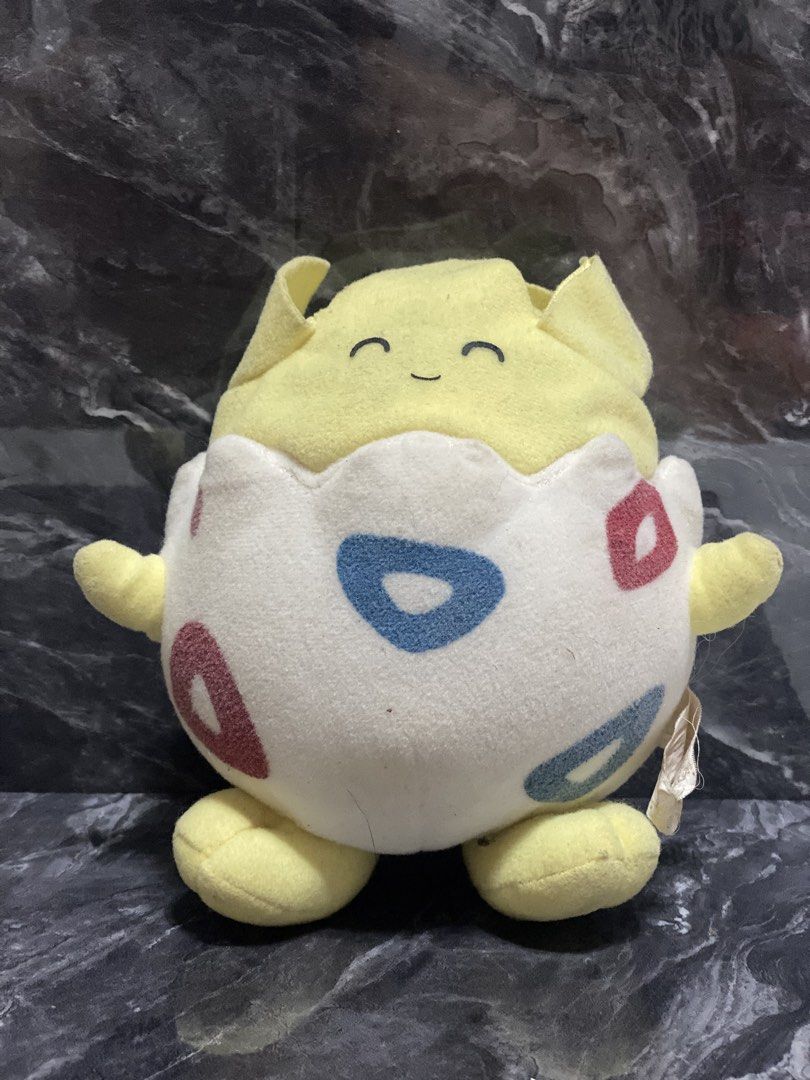 Pokemon Togepi Plush Toy (Category: Plushies & Soft Toys) located in Manila. Submitted by kuya_moto (Listing ID 1454610939, Image 1). Description: - Adorable Togepi plush toy - Classic yellow and white color scheme with red and blue markings - Super soft and cuddly material - Compact and portable size - Ideal gift for any Pokemon enthusiast - Ready to find its new trainer!.