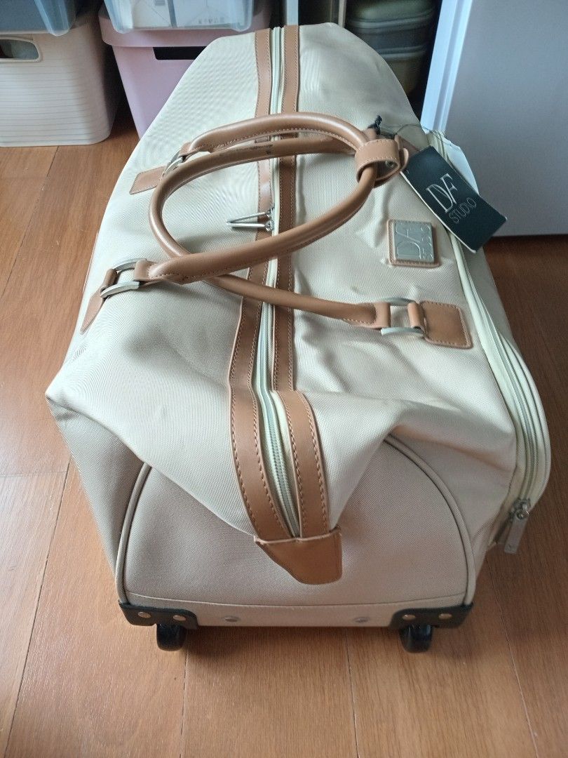 Pre-loved DVF Carry-On Weekender Bag (Category: Luxury Bags & Wallets) located in Manila. Submitted by wildocean.cad79b (Listing ID 1454605953, Image 2). Description: - Beige duffel bag with tan leather accents - Built-in wheels and retractable handle for effortless travel - Ample interior space for all your essentials - Convenient front zip pocket for quick access - Brand new with original tags still attached - Ideal for weekend getaways or as a