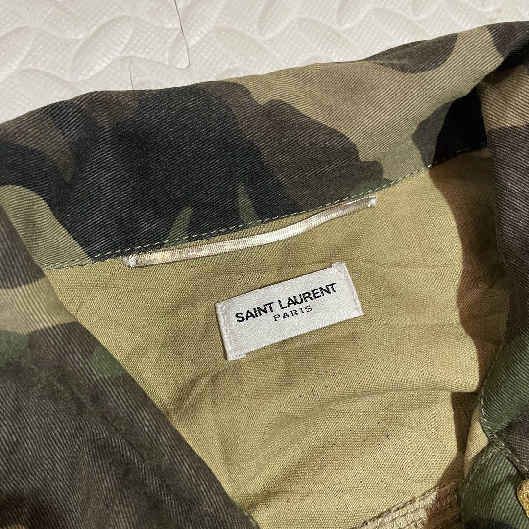Saint Laurent Paris Camo Jacket with Gold Trim (Category: Coats, Jackets and Outerwear) located in Zamboanga. Submitted by selvege (Listing ID 1454749444, Image 3). Description: - Authentic Saint Laurent Paris jacket - Classic camouflage print - Gold trim accent on collar and placket - Button closure with branded buttons - Made in Italy - Size 42 Dimes 21.5 x 28.