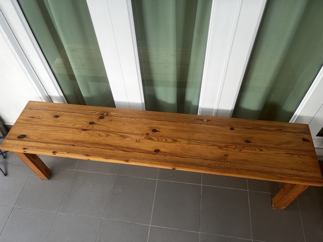 Solid Wood Pine Bench (Category: Chairs) located in Singapore. Submitted by rustycrusty (Listing ID 1454569426, Image 2). Description: - Sturdy pine wood bench - Versatile: entryway, dining, or extra seating - Unique natural wood grain and knots - Solid construction with visible joinery - Dimensions: Approx. [Length 166 cm] x [Width 36 cm]x [Height 46 cm] - Adds a rustic charm to your home - Signs of wear at bottom of legs - Pickup at my residenc