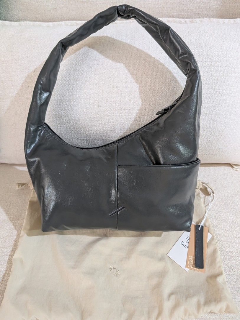 The Paper Bunny Mini Arc Gunmetal (Category: Shoulder Bags) located in Manila. Submitted by cart_rd (Listing ID 1454652725, Image 1). Description: - Dark grey shoulder bag - Shiny, patent-like material - Main zip compartment - Exterior pocket - Small embossed logo on the side - Comes with a dust bag - Ideal for everyday use - used once only, very good condition .