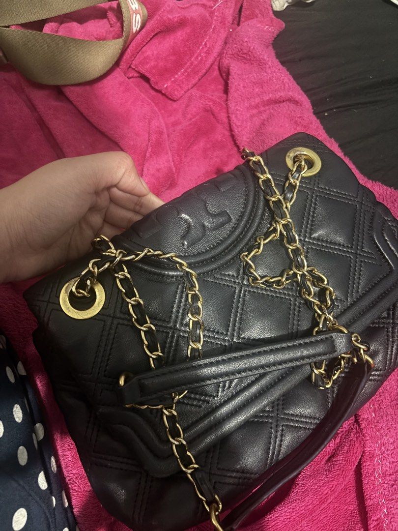 Tory Burch Black Leather Quilted Chain Shoulder Bag (Category: Luxury Bags & Wallets) located in Mandaluyong City. Submitted by kylienicole.214 (Listing ID 1454565236, Image 3). Description: - Genuine black leather Tory Burch bag - Elegant quilted design - Stylish gold chain strap - Interior features signature gold Tory Burch logo plate - Versatile: ideal for everyday use or evening events - Spacious interior for your essentials.