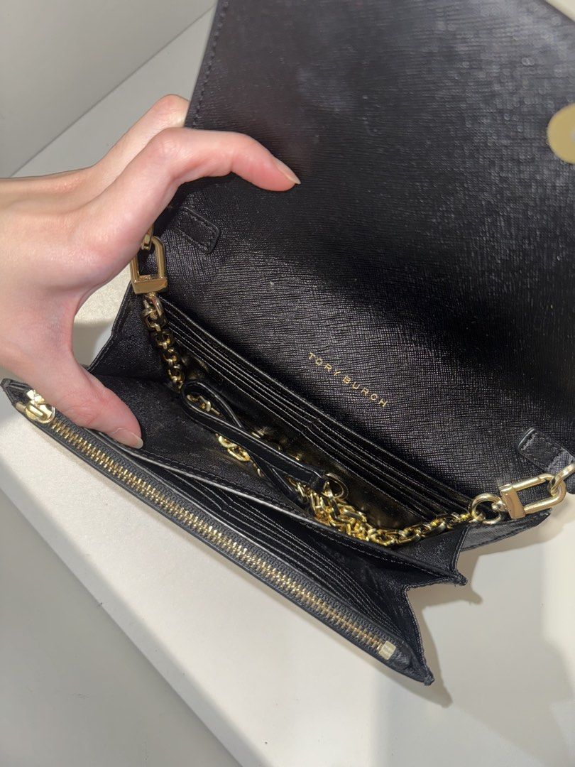 Tory Burch Black Leather Wallet on Chain (Category: Luxury Bags & Wallets) located in Quezon City. Submitted by mckdonaldssss (Listing ID 1454652680, Image 3). Description: - Authentic Tory Burch wallet on chain - Chic black leather exterior - Elegant gold chain strap - Interior card slots for organization - Convenient zip pocket for coins or small items - Secure magnetic snap closure on front flap - Iconic gold Tory Burch logo embellishment - Id
