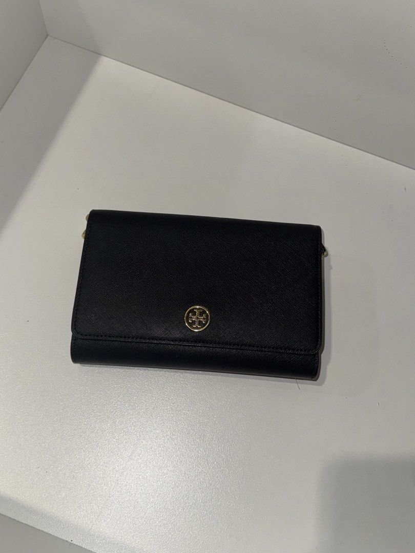 Tory Burch Black Leather Wallet on Chain (Category: Luxury Bags & Wallets) located in Quezon City. Submitted by mckdonaldssss (Listing ID 1454652680, Image 1). Description: - Authentic Tory Burch wallet on chain - Chic black leather exterior - Elegant gold chain strap - Interior card slots for organization - Convenient zip pocket for coins or small items - Secure magnetic snap closure on front flap - Iconic gold Tory Burch logo embellishment - Id