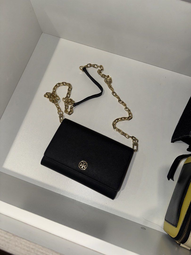 Tory Burch Black Leather Wallet on Chain (Category: Luxury Bags & Wallets) located in Quezon City. Submitted by mckdonaldssss (Listing ID 1454652680, Image 2). Description: - Authentic Tory Burch wallet on chain - Chic black leather exterior - Elegant gold chain strap - Interior card slots for organization - Convenient zip pocket for coins or small items - Secure magnetic snap closure on front flap - Iconic gold Tory Burch logo embellishment - Id