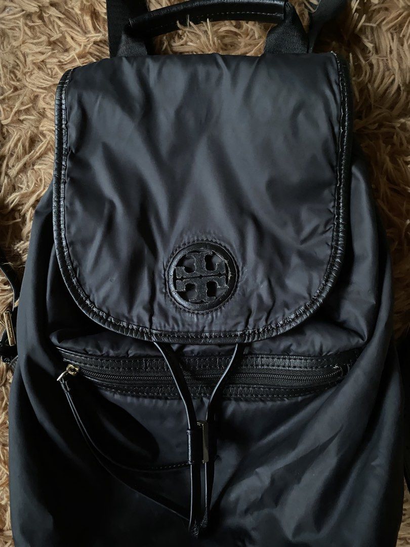Tory Burch Virginia Backpack Nylon/Leather (Category: Luxury Bags & Wallets) located in Cebu City. Submitted by patspickph (Listing ID 1454664884, Image 2). Description: This is a Tory Burch Virginia Backpack featuring a black nylon body, a drawstring closure, and a flap top with an embossed logo. Original/ Authentic bag. Minimal sign of usage still in excellent condition👍.