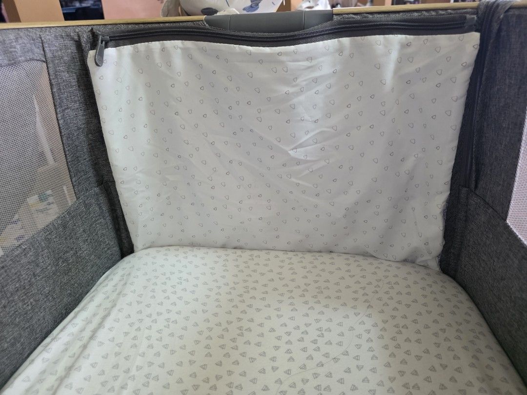 Tutti Bambini CoZee Air Bedside Crib Grey (Category: Cots & Cribs) located in Silang. Submitted by gooddealclub (Listing ID 1454616241, Image 3). Description: - Tutti Bambini CoZee Air bedside crib - Stylish grey fabric with natural wooden legs - Mesh sides for excellent ventilation - Convenient storage shelf underneath - Includes mattress and two(2) pcs fitted sheet - Easy to assemble and portable with wheels - Ideal for co-sleeping and keeping 