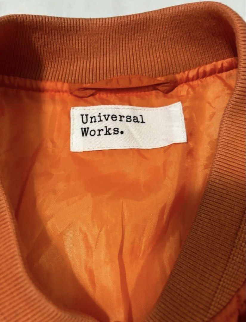 Universal Works Quilted Bomber Jacket Orange (Category: Coats, Jackets and Outerwear) located in Quezon City. Submitted by edether (Listing ID 1454729032, Image 2). Description: - Orange quilted bomber jacket by Universal Works - Zip-up front with button closure - Ribbed collar, cuffs, and hem - Two front pockets - Outer: 100% Polyamide - Lining & Filling: 100% Polyester - Ideal for layering Like new condition Width - 22in Length- 26in If you see