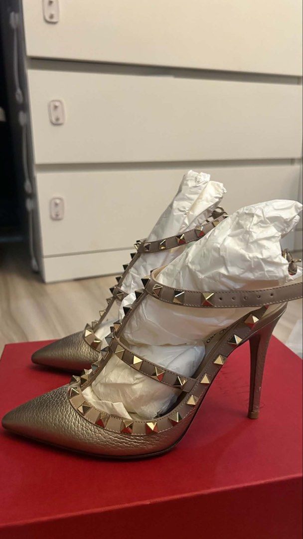Valentino Rockstud Heels Gold Metallic Leather Slingbacks (Category: Heels) located in Quezon City. Submitted by mitchy09 (Listing ID 1454573897, Image 2). Description: - Valentino Rockstud heels in stunning gold metallic leather. - Chic slingback design with an adjustable ankle strap. - Features the iconic Valentino pyramid studs for a signature look. - Elegant pointed toe. - Comes complete with the original box and dust bag. - Perfect for eleva