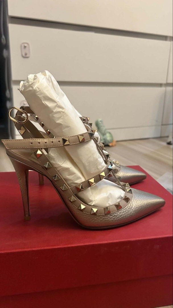 Valentino Rockstud Heels Gold Metallic Leather Slingbacks (Category: Heels) located in Quezon City. Submitted by mitchy09 (Listing ID 1454573897, Image 3). Description: - Valentino Rockstud heels in stunning gold metallic leather. - Chic slingback design with an adjustable ankle strap. - Features the iconic Valentino pyramid studs for a signature look. - Elegant pointed toe. - Comes complete with the original box and dust bag. - Perfect for eleva