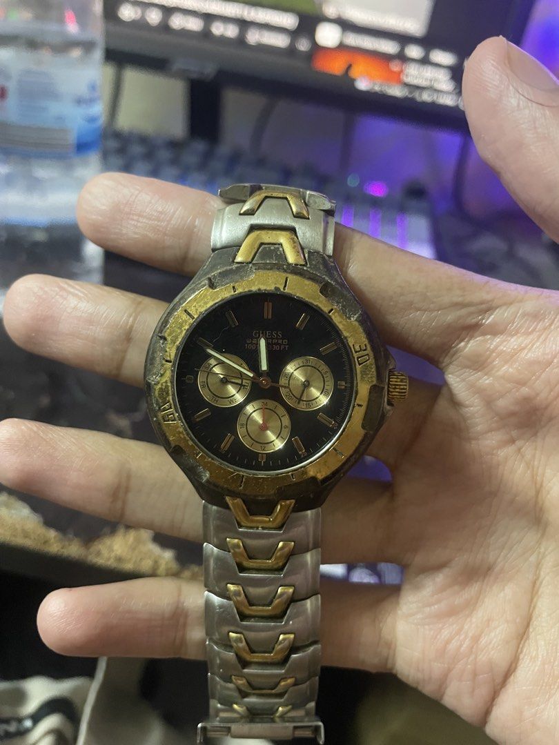 Vintage Guess Waterpro Watch (Category: Men's Watches) located in Manila. Submitted by 2002kid (Listing ID 1454687266, Image 1). Description: vintage GUESS Waterpro chronograph Color: Two tone Silver and Gold watch featuring a two-tone silver and gold stainless steel design with a black dial. The watch is rated for 50 meters (165 feet) of water resistance.It includes a rotating bezel and analog quartz movement. Issue: Need Polish And Fix Not Work