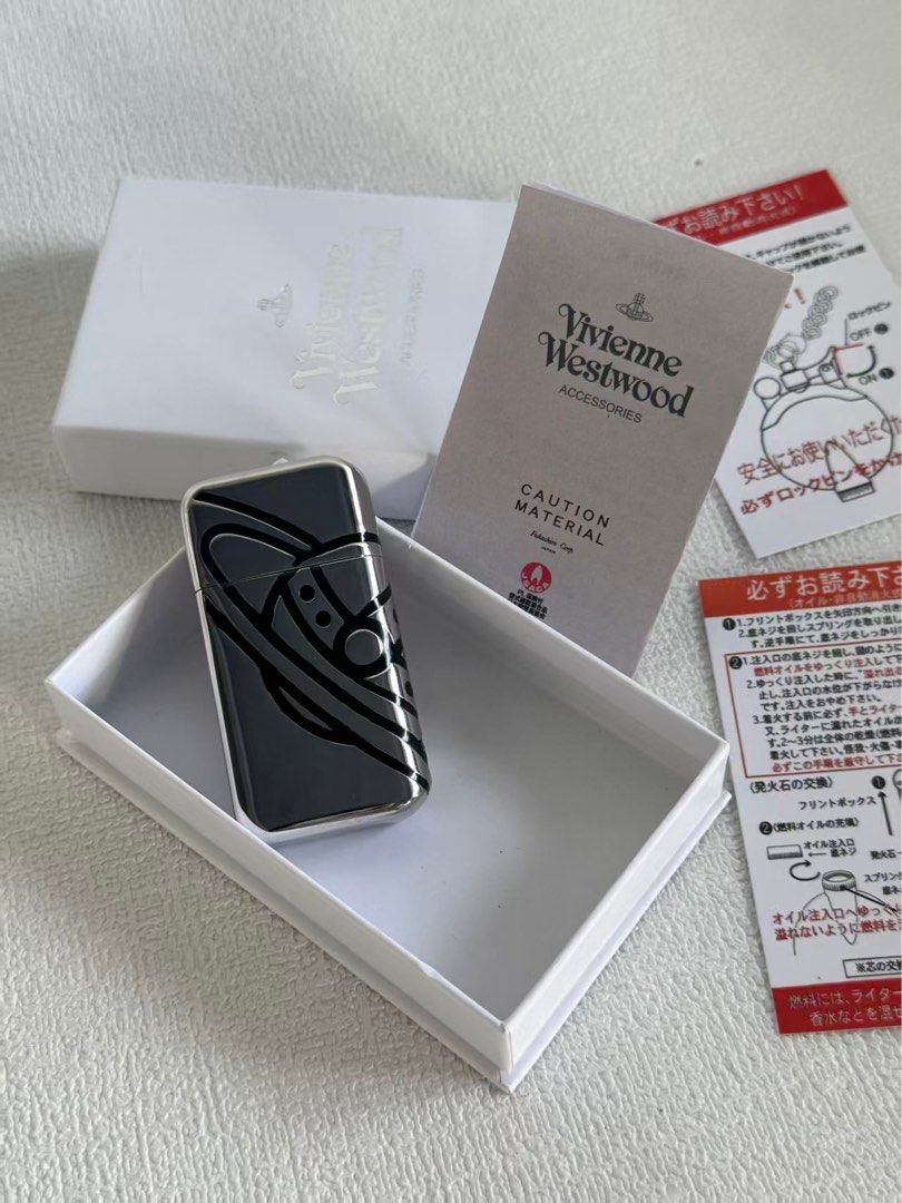 Vivienne Wetswood Lighter (Category: Luxury Accessories) located in Manila. Submitted by distinct_mnl (Listing ID 1454724854, Image 2). Description: BIG ORB Oil Lighter: VW-5317 Silver Condition: Brand New and Unused Set Item: Namii Original Coasters *Design cannot be selected Accessories: Genuine storage box, shop bag. Size: Length 2.6 inches (6.5 cm), Width 1.2 inches (3.0 cm), Width 0.4 inches (1.0 cm) Oil lighter with simple and sharp line OR