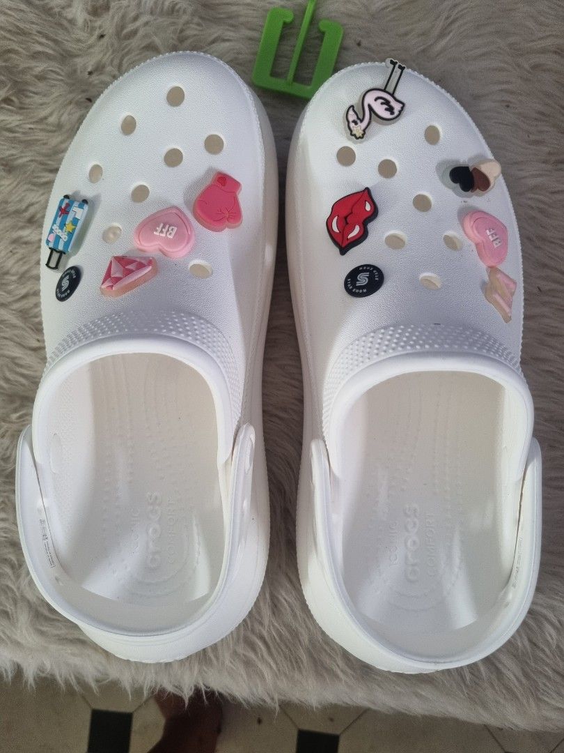 White Crocs with Cute Jibbitz Charms (Category: Slippers and slides) located in Manila. Submitted by monya111 (Listing ID 1454614167, Image 1). Description: - White Crocs clogs - Customized with fun Jibbitz charms - Includes: flamingo, lips, hearts, and a suitcase - Adds personality to your outfit - Easy slip-on style - Comfortable for everyday wear - Perfect for casual outings or lounging.