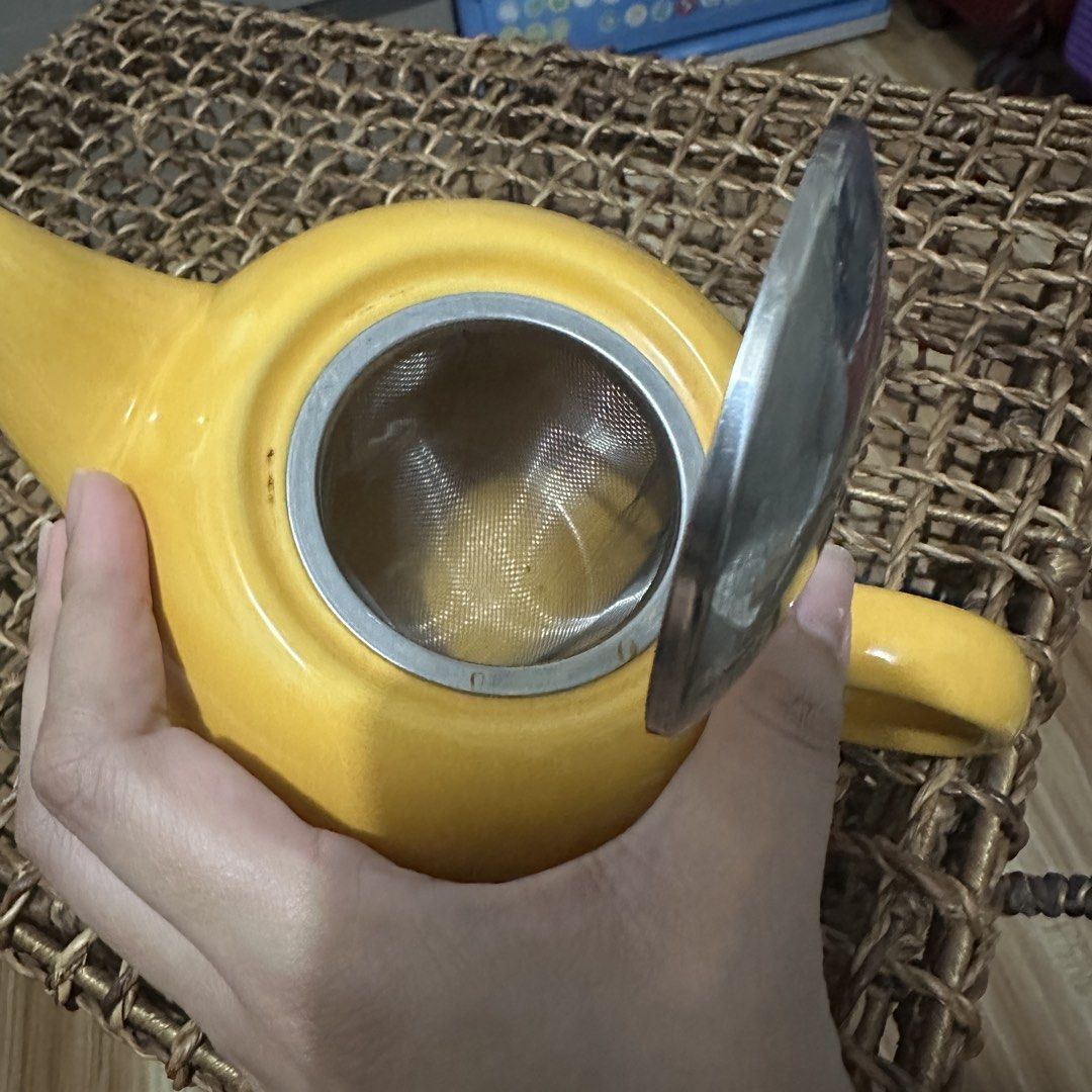 Yellow Ceramic Teapot with Stainless Steel Infuser (Category: Coffee & Tea Tableware) located in Kawit. Submitted by wevibevintage (Listing ID 1454687300, Image 3). Description: - Adorable yellow teapot, perfect for loose leaf tea. - Features a removable stainless steel infuser basket. - Lid has a secure clasp. - Ideal for personal use or as a thoughtful gift. - Easy to clean and store. - Brightens up any kitchen space..