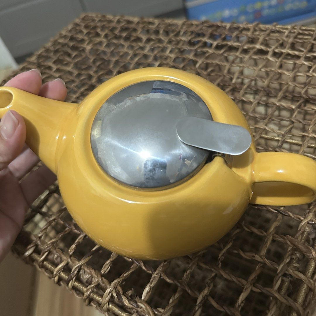 Yellow Ceramic Teapot with Stainless Steel Infuser (Category: Coffee & Tea Tableware) located in Kawit. Submitted by wevibevintage (Listing ID 1454687300, Image 2). Description: - Adorable yellow teapot, perfect for loose leaf tea. - Features a removable stainless steel infuser basket. - Lid has a secure clasp. - Ideal for personal use or as a thoughtful gift. - Easy to clean and store. - Brightens up any kitchen space..